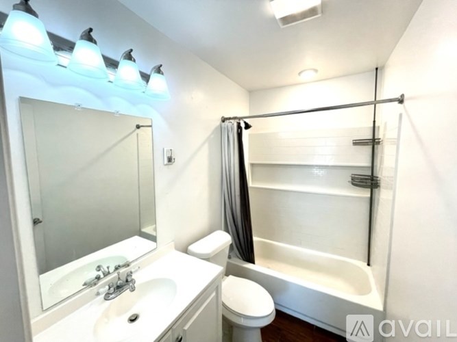 A bathroom with a white sink, toilet, and bathtub.