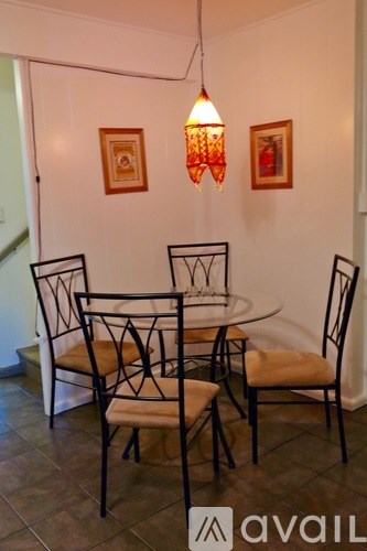A dining room with a table and chairs.
