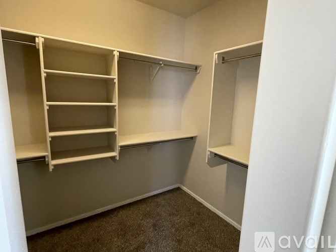 A small, empty room with shelves and a door.