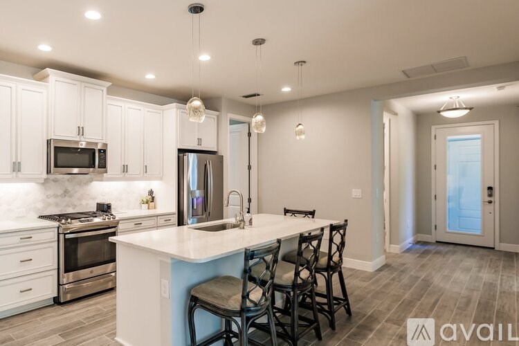 A kitchen with a white countertop and a blue accent wall.