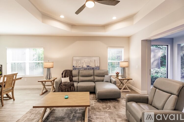 A living room with a variety of furniture including a couch, chairs, and a coffee table.