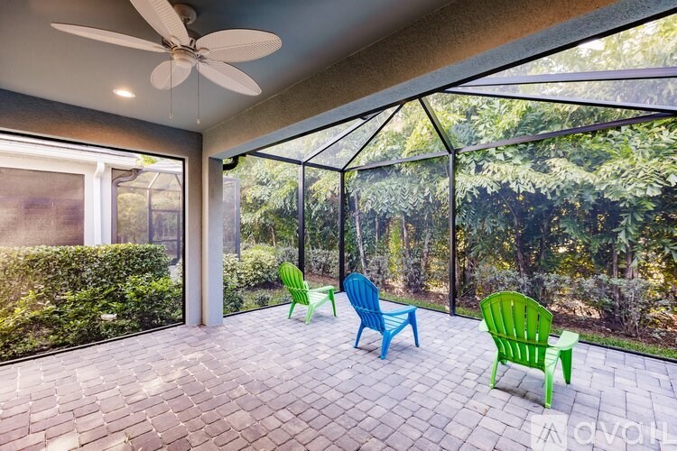 A patio with a ceiling fan and four chairs.
