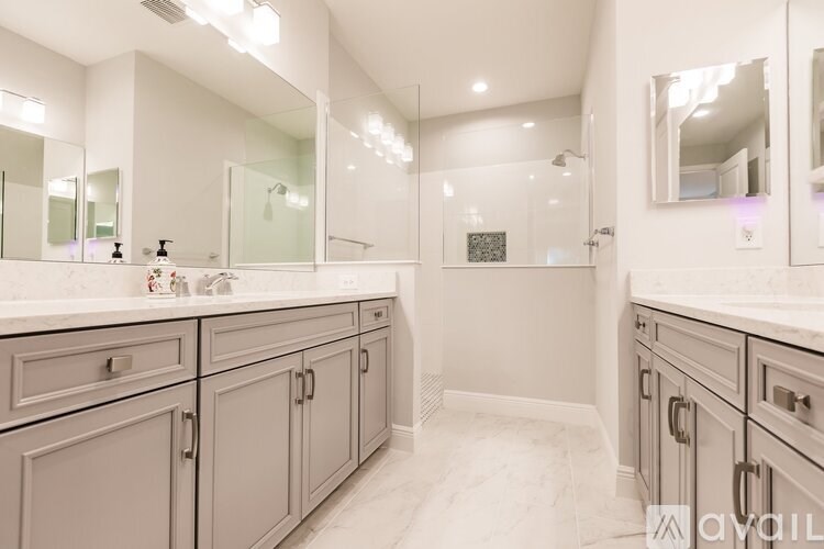 A bathroom with a vanity and a shower.