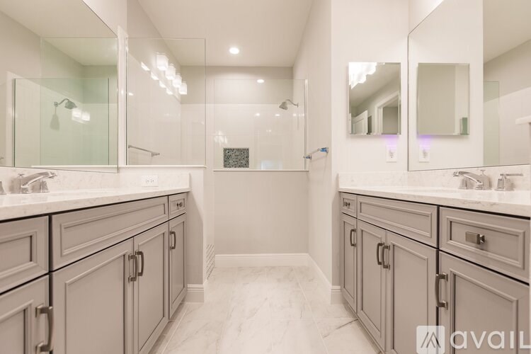 A bathroom with two sinks and a large mirror.