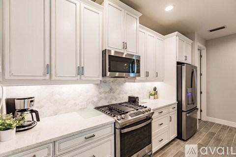 A kitchen with white cabinets and a black stove top.