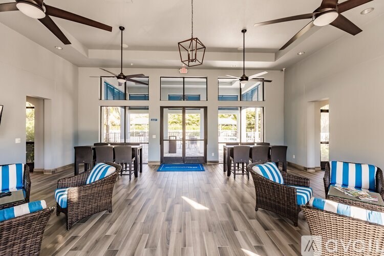 A living room with a wooden floor and ceiling fan.