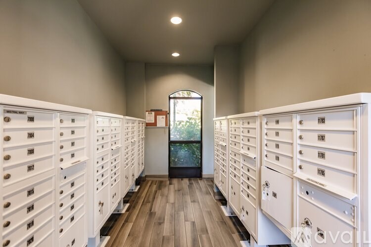 A hallway with a row of mailboxes on either side.
