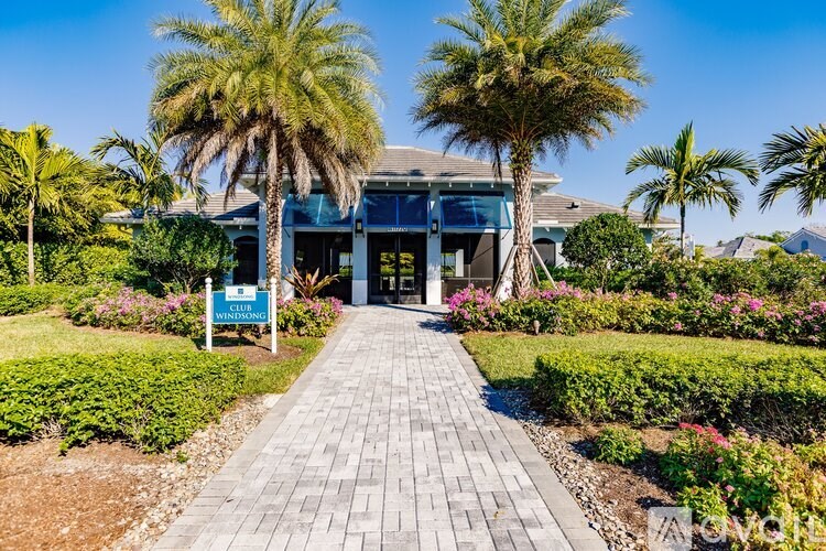 A pathway leads to a building with a sign that reads "Sunrise.".