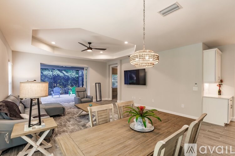 A living room with a wooden floor and a ceiling fan.