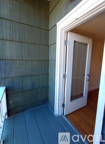 A white door is open to a hallway.