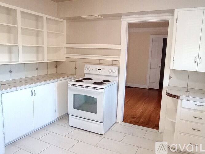 A white kitchen with a stove and oven.