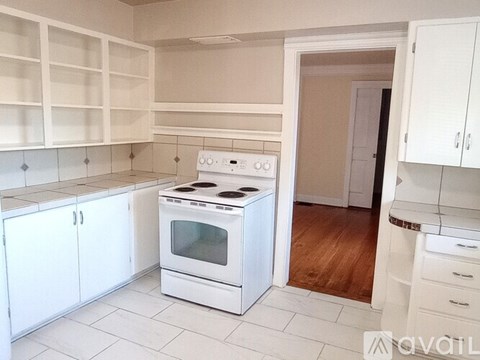 A white kitchen with a stove and oven.