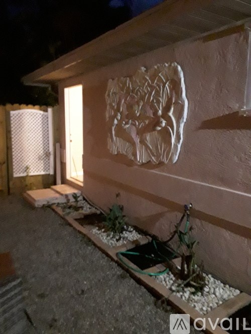 A wall with a white carving of a tree on it.