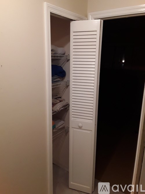 A white refrigerator with its door open and shelves inside.