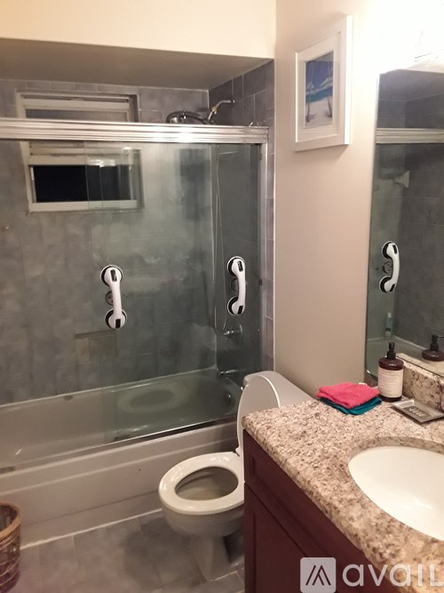 A bathroom with a toilet, sink, and shower.