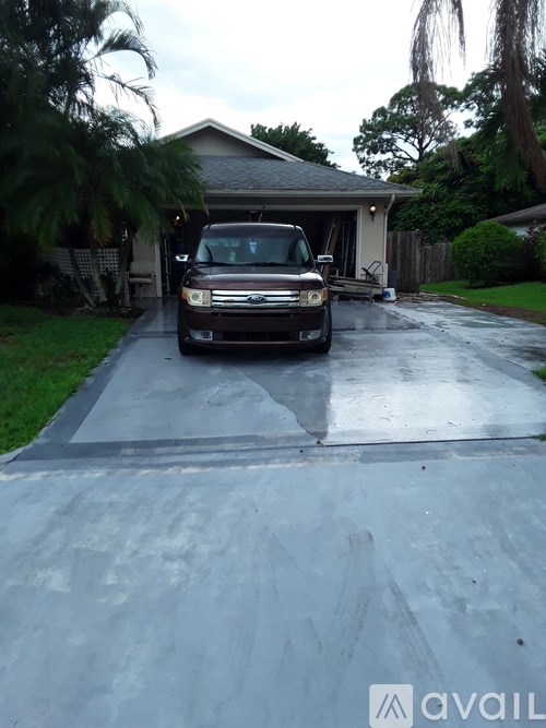 A brown truck is parked on a driveway.