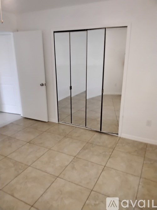 A room with a white door and a glass partition.