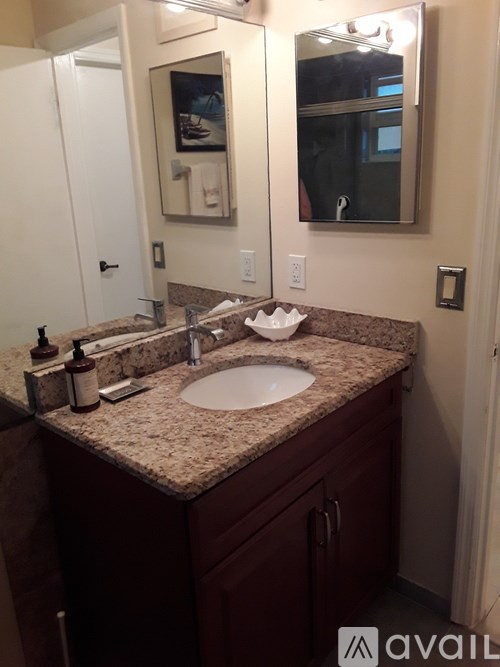 A bathroom with a sink and a mirror.