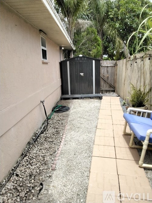 A small backyard with a pool and a hot tub.