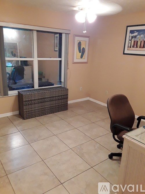 A room with a brown chair and a brown wicker table.
