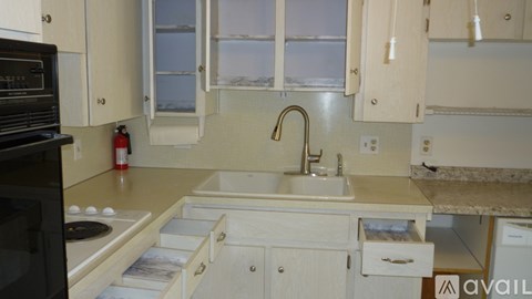 A kitchen with white cabinets and appliances.