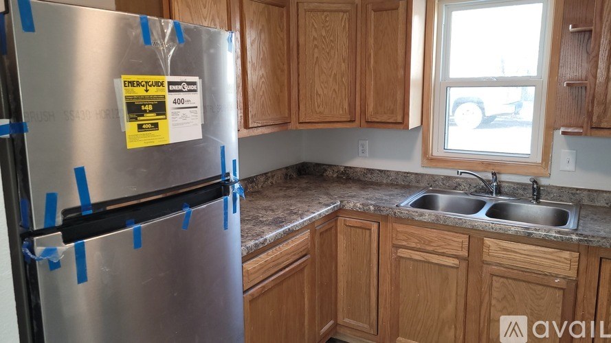 A stainless steel refrigerator with a label on it in a kitchen.
