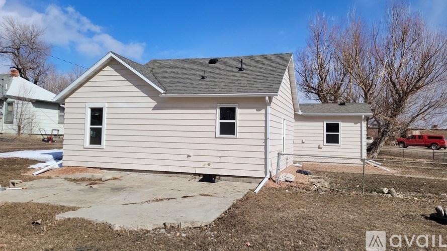 A two-story house with a grey roof and white siding is for sale.