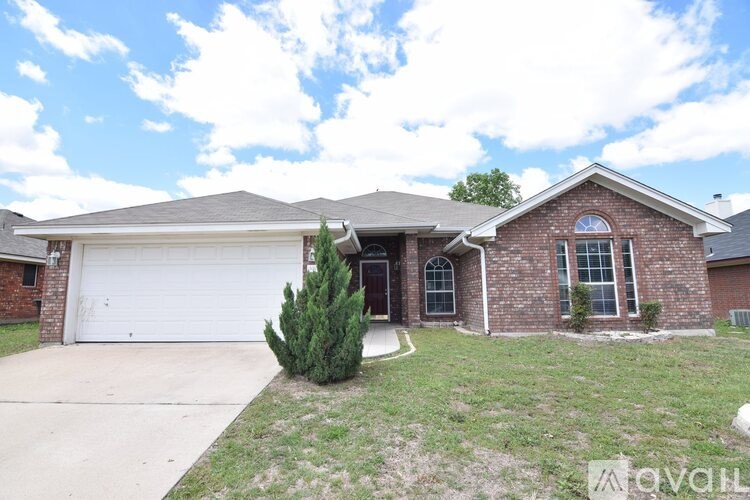 A brick house with a white garage door.