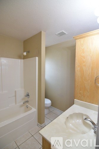 A bathroom with a sink, toilet and bathtub.