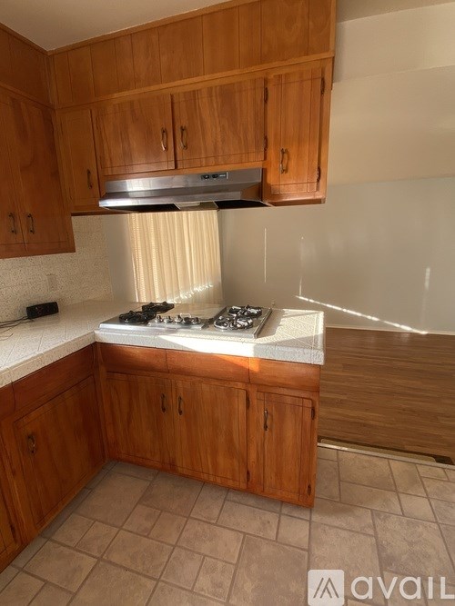 A kitchen with wooden cabinets and a white countertop.