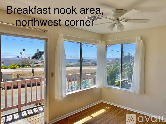 A room with a northwest corner breakfast nook area with a ceiling fan.