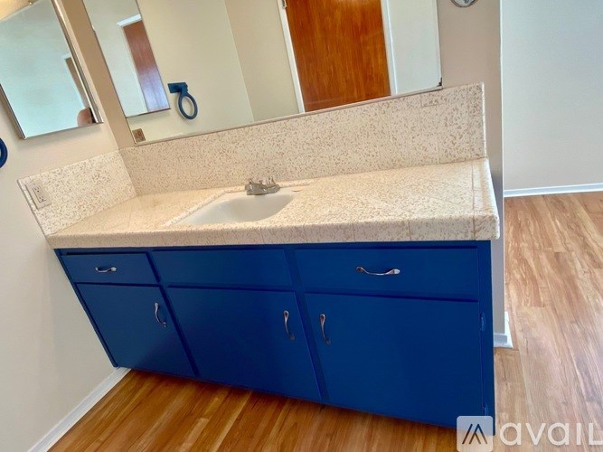 A bathroom vanity with a sink and a mirror.