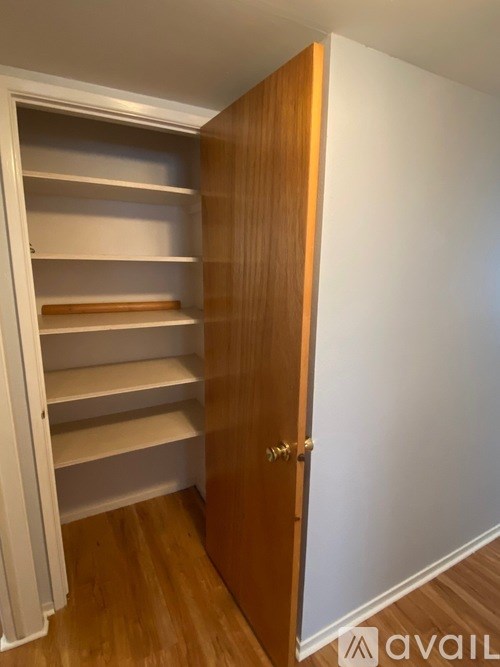 A wooden door with a shelf underneath it.