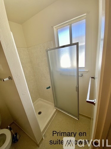 A small bathroom with a walk in shower and a toilet.