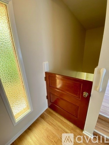 A wooden door with a handle is in the room.