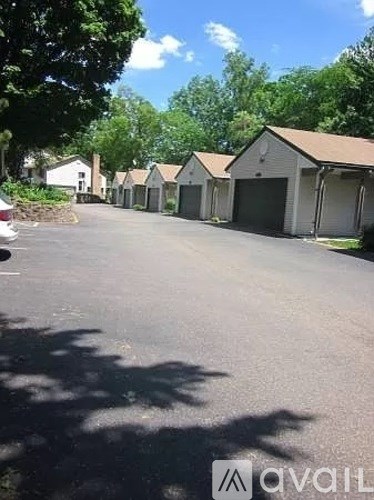 A row of houses with a car parked in front of the first one.