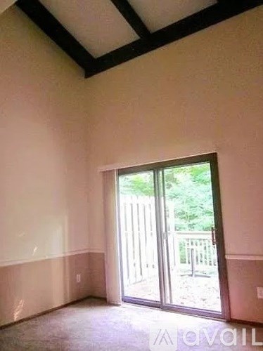 A room with a sliding glass door leading outside.