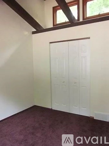A room with a white door and a window.