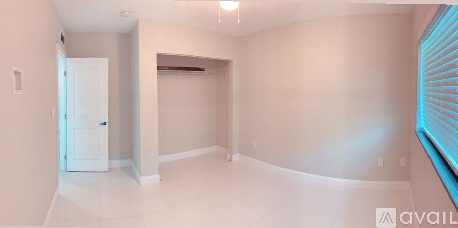 A spacious room with a door and a window.