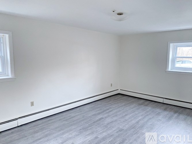 A room with a grey floor and white walls.