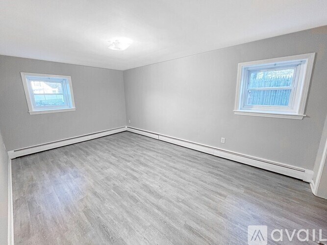 A room with grey walls and a wooden floor.