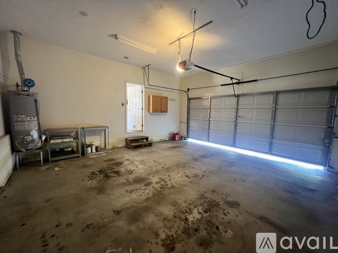 A dirty garage with a white door and a window.
