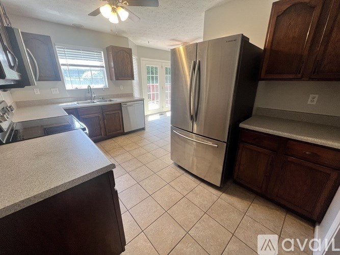 A kitchen with a refrigerator, stove, and sink.