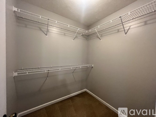 Empty white shelves in a room.