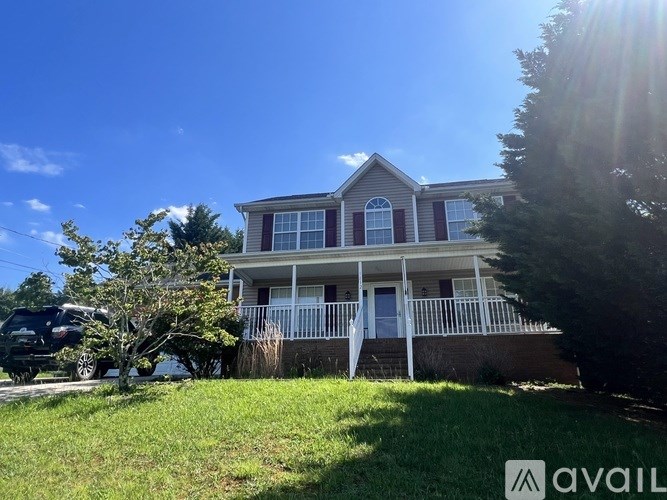 A house with a car parked in front of it.