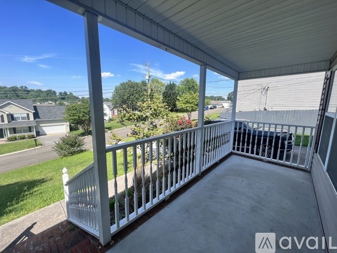 A white metal railing on a covered porch.