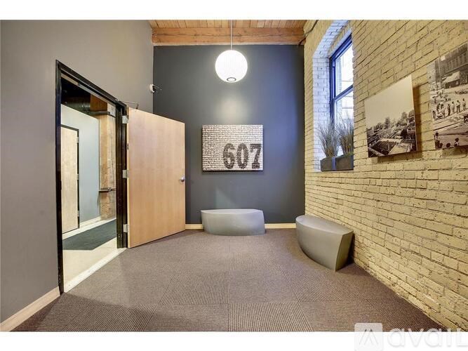 A room with a brick wall and a door leading to a balcony.