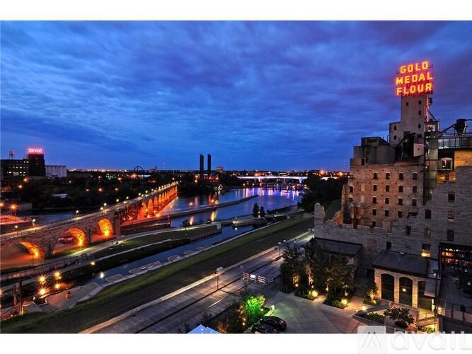 A building with a sign that says "Gold Medal Flour" is lit up at night.