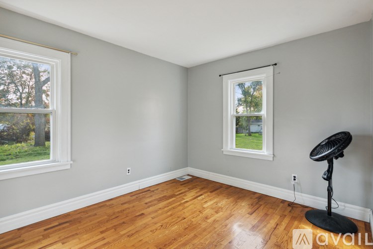 A room with a window and a fan.
