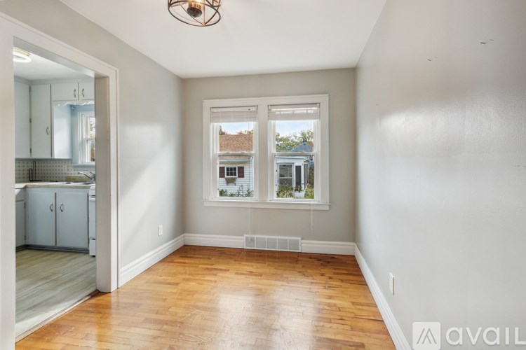A room with a window and a view of a building outside.
